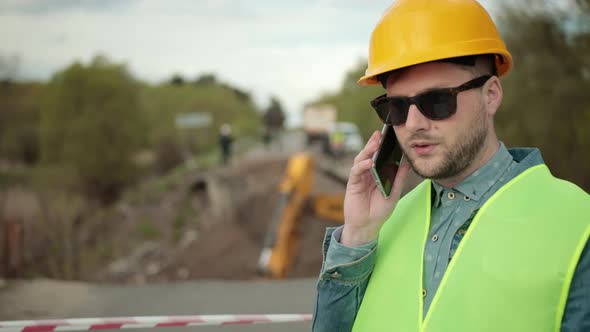 Portrait of Young Man Working Speaking By Phone alt
