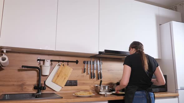 Woman Prepares Pancakes and Scolds Man Who Sneaked Up and Stole Pancake alt