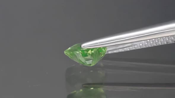 Natural Green Garnet Heart Cut Tsavorite Mineral Gemstone in the Tweezers