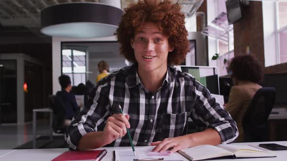 Happy mixed race businessman having video call sitting in front of computer alt