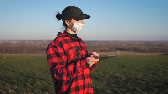 Agronomist Using a Digital Tablet in an Agriculture Field alt