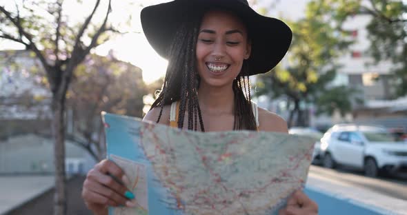 Bohemian mixed race young woman looking on city map - Summer vacation, travel and lifestyle concept alt