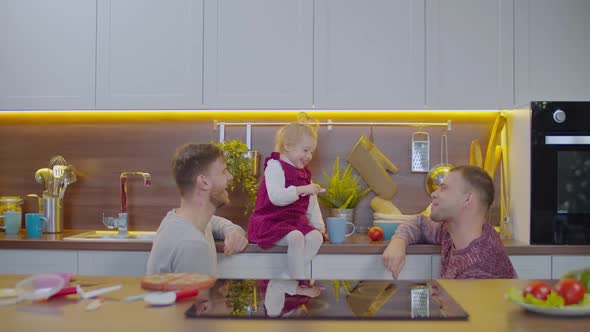 Happy Same Sex Parents Child Resting Home alt