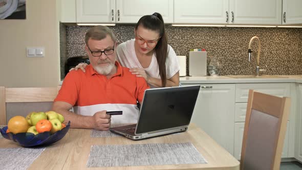 Beautiful Young Woman Is Explaining To Her Elderly Father How To Shop Online alt