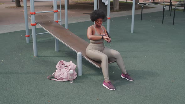 Plus Size Woman Resting after Outdoor Workout alt