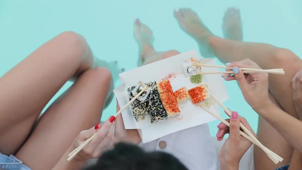 Appetizer Sushi food set. Womens hands taken with chopsticks delicious fresh roll Philadelphia alt