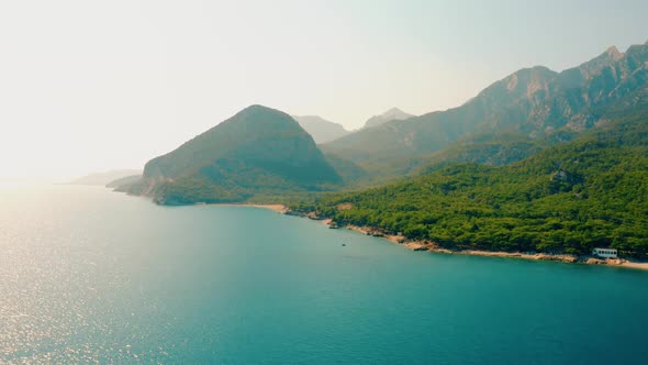 Beautiful Landscape with Turquoise Sea Water and Green Mountains alt