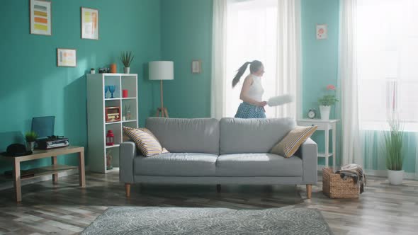 Energetic Woman Is Dancing with Cleaning Brush