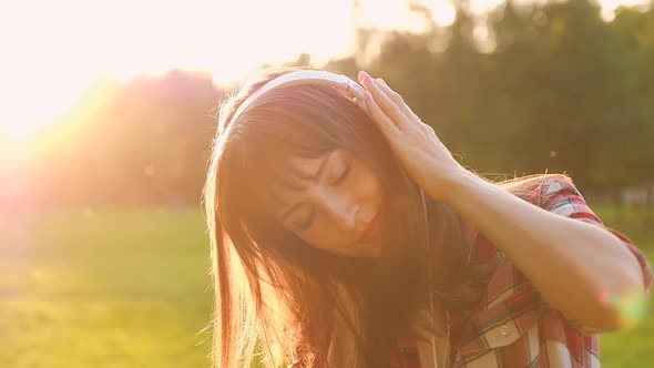 Portrait of a charming young positive woman listening to favorite online radio