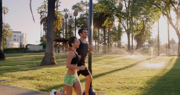 Athlete Couple Jogging In The Park alt