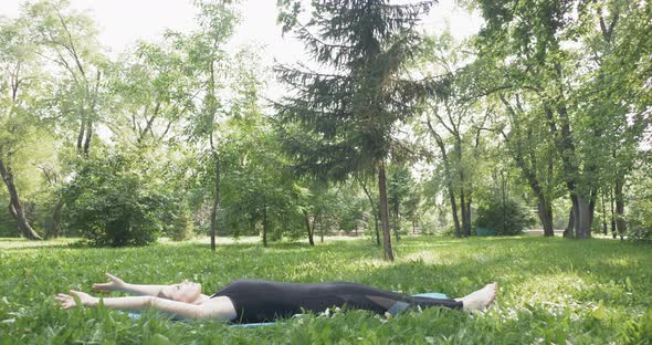 Beautiful Woman Doing Pilates in the Green Park