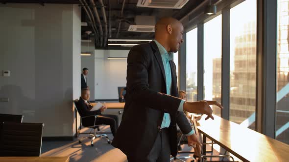 Happy African American Businessman Celebrating Promotion with Funny Dance Walk alt