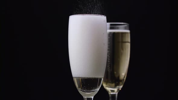 Champagne Poured Into Glass. Black Background. Close Up alt