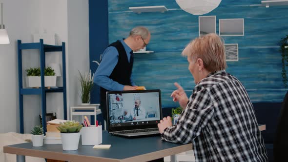 Young Doctor Video Conferencing Senior Woman alt