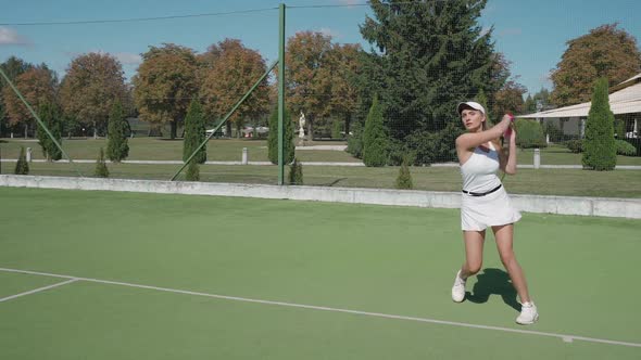 Professional Tennis Player Hits the Ball with a Racket Female Hits Off the Opponent's Serve During alt