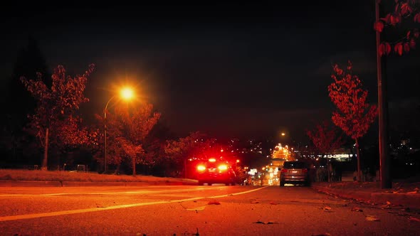 Cars Drive Down Hill In City At Night by RockfordMedia | VideoHive