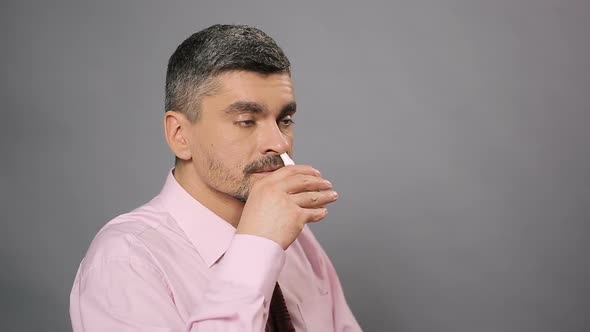 Sick Man With Beard Using Nasal Spray, Allergy, Medicine and Health Care alt