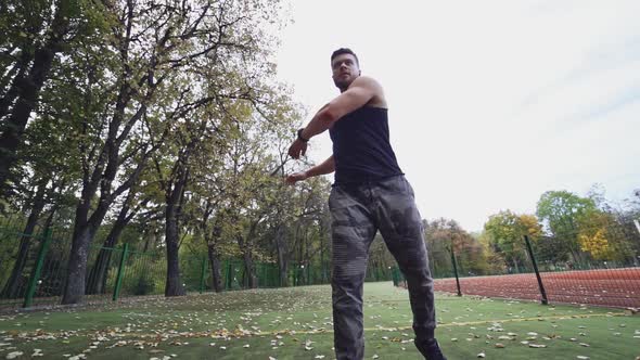 Healthy athlete doing his workout outdoors. Sportive man is exercising alt