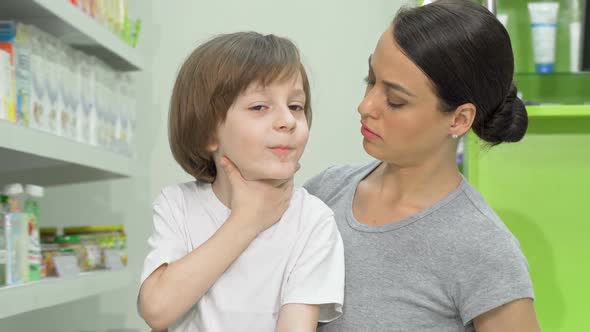 Beautiful Woman Looking Disturbed As Her Little Son Coughing and Having Fever