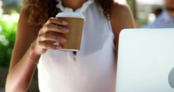 Woman having coffee at restaurant alt