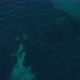 Drone shot over shallow, turquoise ocean, revealing the coast of Mallorca - VideoHive Item for Sale