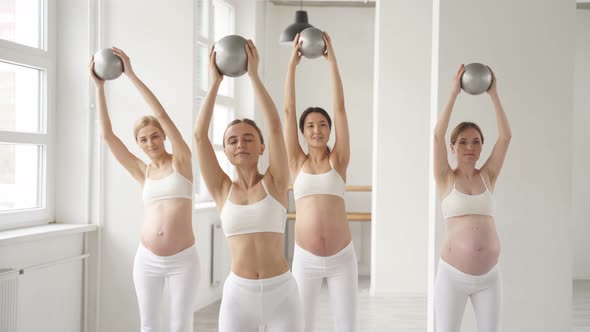 Group of Young Gravid Women in Sportswear Doing Exercises with Fitness Balls