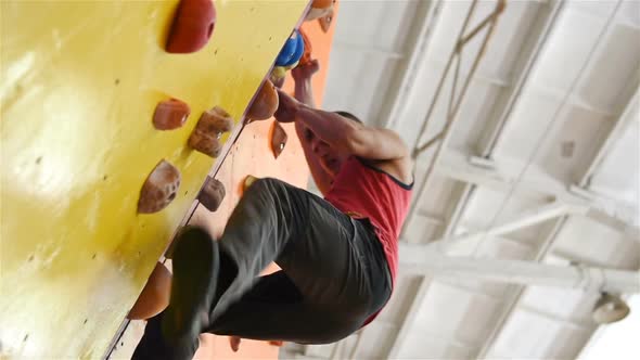 Man Climbing On Practice Wall