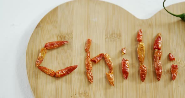 Dried red chili pepper arranged in chili text with green chili 4k alt