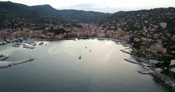 Gorgeous coastal town and marina on Riviera di Levante, Italy; aerial arc alt