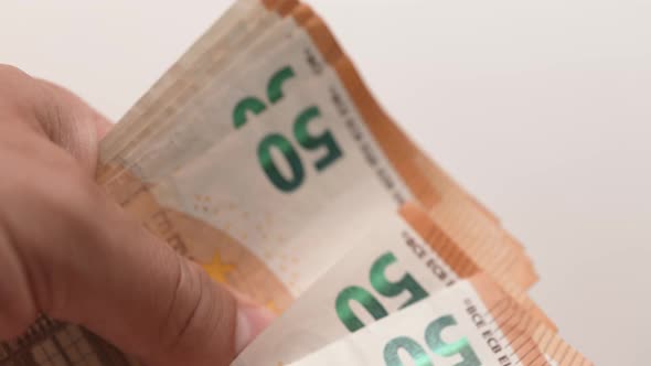 Male Hands Counting a Stack of 50 Euros Banknote alt