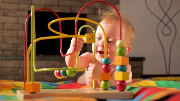 The baby develops fine motor skills. Montessori toy. Toddler playing with a Montessori toy.