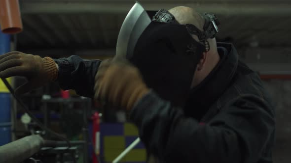 A Welder Works in a Workshop alt