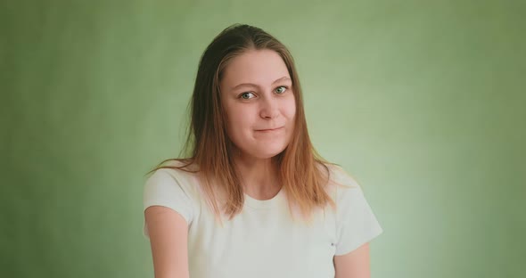 Lady in White Tshirt Threatens By Fist and Finger on Green alt