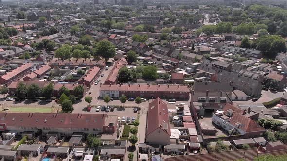 aerial view of drone flying over a dutch neighborhood on a summer day, loads of terraced houses, gar alt