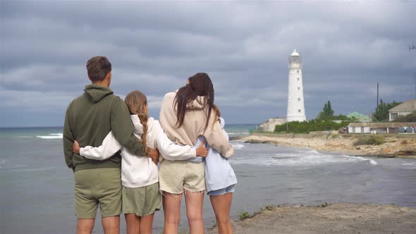 Family of Four Walk To the Lighthouse