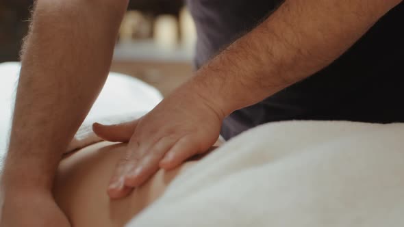 Male Masseur Hands Burn Fat by Anti-Cellulite Massage. Woman Receiving Stomach Massage in Spa Salon