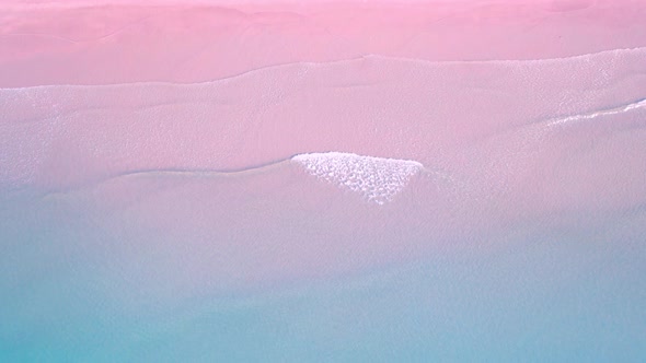 4K Aerial view top view of drone, blue sea waves and beautiful pink sand beach. alt