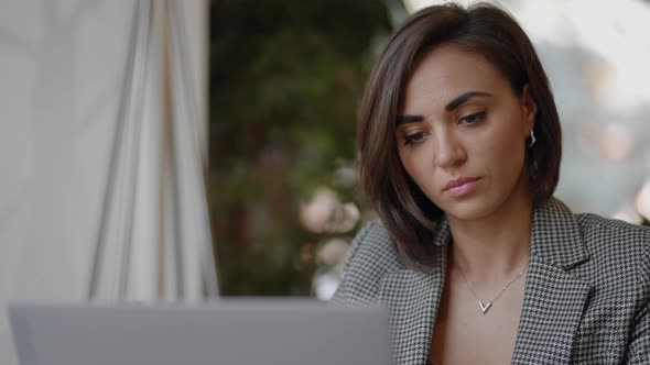 A Young Beautiful Woman is Sitting on a Chair and Writing Down or Taking Down Notes While Attending alt