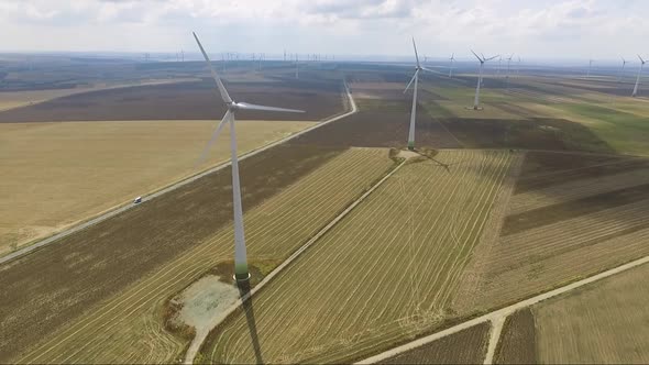 Aerial shot of road going through wind farm