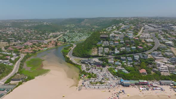 River Flowing Through Coastal Town and Its Estuary to Sea at Sand Beach alt