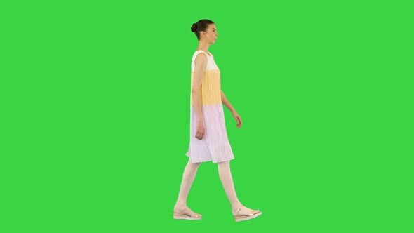 Young Beautiful Girl In Whiteyellow Dress Walks On A Green Screen Chroma Key By Funkeyrec