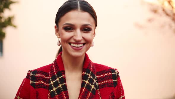 Adorable Young Happy Girl in Red Trendy Clothing Walking Outdoor Turning Around Looking at Camera