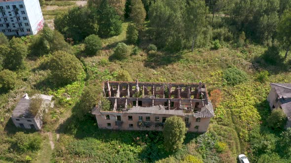Aerial View of Abandoned and Destroyed Buildings From the Times of the USSR in a Green Picturesque alt