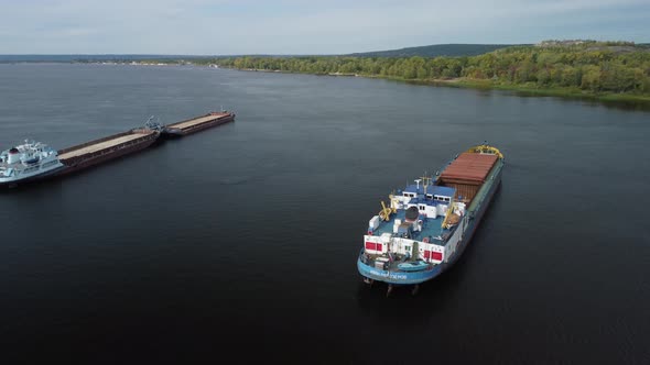 Aerial view of two dry cargo ships at anchor on Volga river.