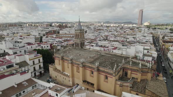 Historic catholic church with Mudejar Gothic architecture, Seville; aerial pan