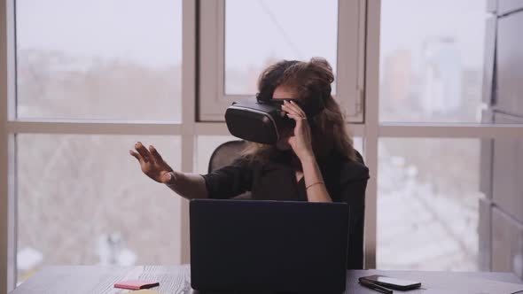Young American Woman in Augmented Reality Glasses Moving Hands