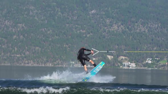 Young man wake boarding on a lake. alt