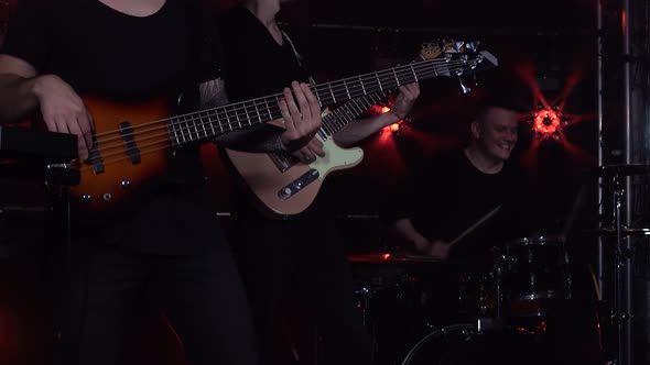 Musicians Play Electric Guitars and Drums in Dark Studio with Smoke and Neon Lighting. Dynamic Neon alt