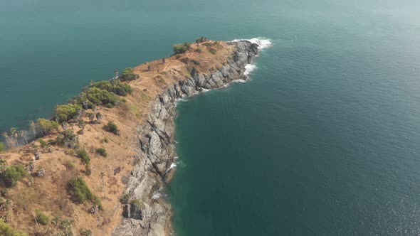View of Promthep Cape, southern most tip of Phuket, Thailand - Aerial Tilt-up Reveal shot alt
