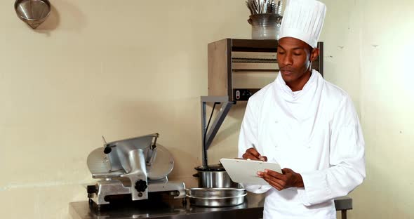 Chef writing on a clipboard alt